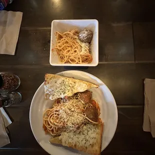 Kids and regular portion of spaghetti with meatball.