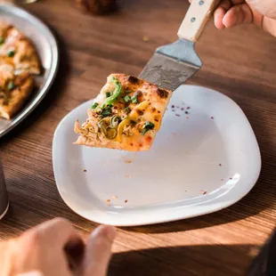 a slice of pizza on a plate with a fork