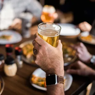 a man holding a glass of beer