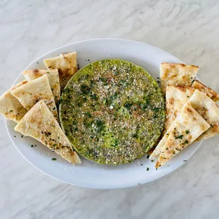 a white plate with pita chips