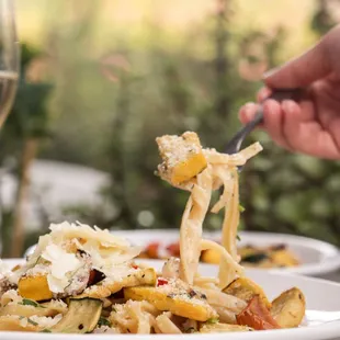 a plate of pasta and a glass of wine