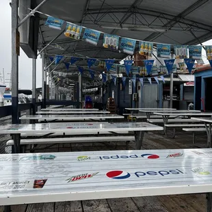 empty picnic tables on a pier