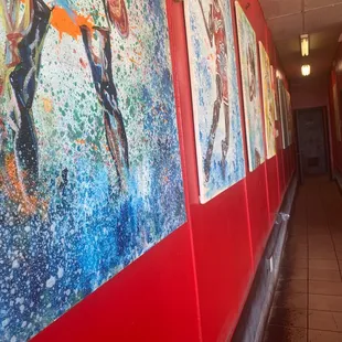 a hallway lined with paintings