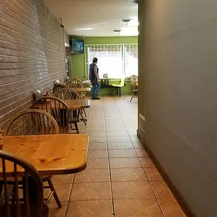 a hallway with tables and chairs
