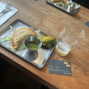 The empanada was very crisp and meaty. The chicken wing was tender and flavorful with the chimichurri sauce.