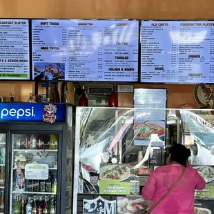 a woman ordering food at a restaurant