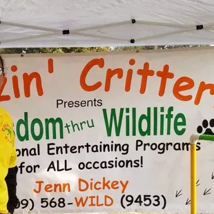 The critters and a volunteer at a festival.