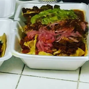 Super Nachos with all the meat pickled onions with bits of habanero and the works even  so bomb