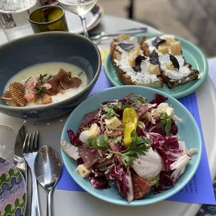 a plate of salad and a bowl of soup