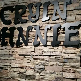  woman sitting in front of a stone wall