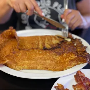 a plate of fried fish and bacon