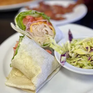 a burrito and salad on a plate