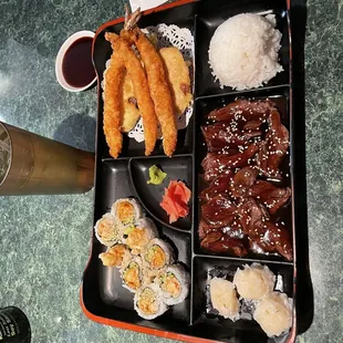 a tray of sushi and rolls
