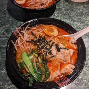 two bowls of soup with chopsticks