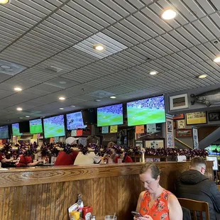 a large group of people sitting at a bar