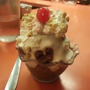 Chocolat ice cream with marshmallow cream, whip cream, nuts and cherry