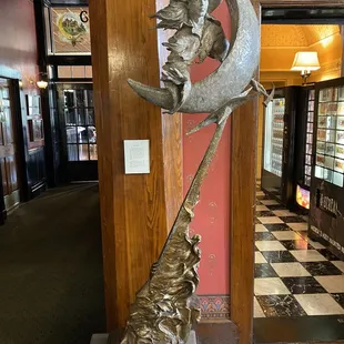 a sculpture of a man on a crescent