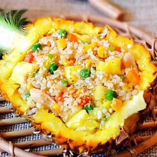 a pineapple filled with rice and vegetables