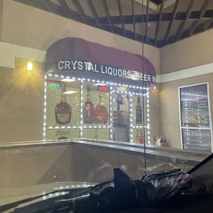 a broken umbrella outside a liquor shop