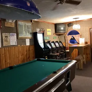a pool table and arcade machines