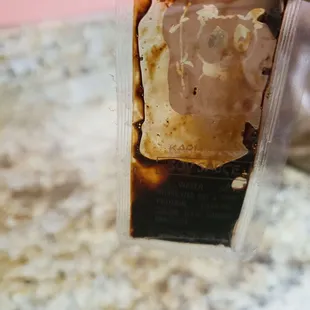 a hand holding a piece of burnt food