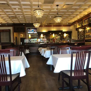 tables and chairs with white tablecloths