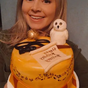 a woman holding a cake