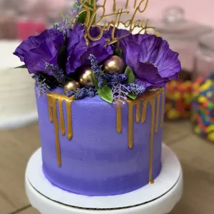 a purple cake with purple flowers