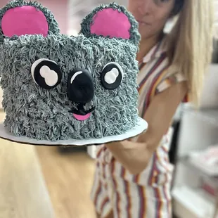 a woman holding a cake