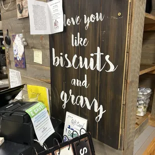 a wooden sign with the words love you like biscuits and gravy