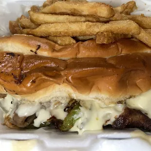 Philly steak sandwich and fries