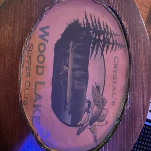 a wooden plate with a picture of a boat on it
