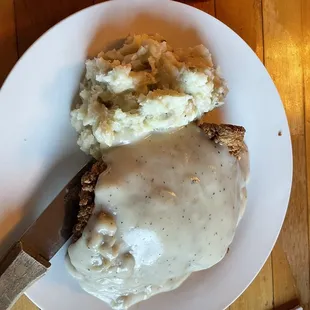 Chickens fried steak with homemade potatoes and gravy.