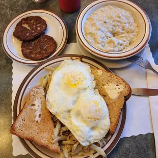 a breakfast of eggs, hash browns, and toast