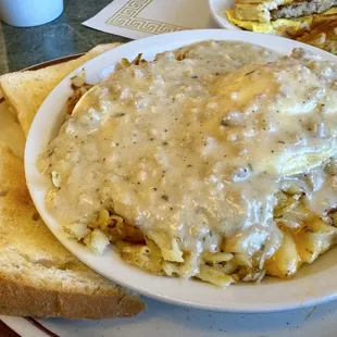 Wisconsin Country Skillet C&apos;s hashbrowns topped with two eggs smothered in sausage gravy and served with homemade toast
