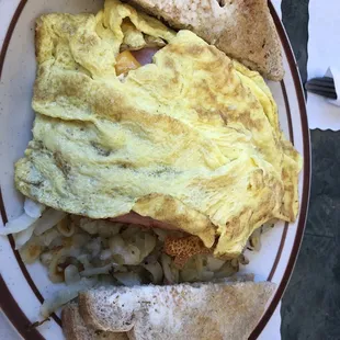 Hash browns coved with onions, cheese, ham &amp; 2 eggs