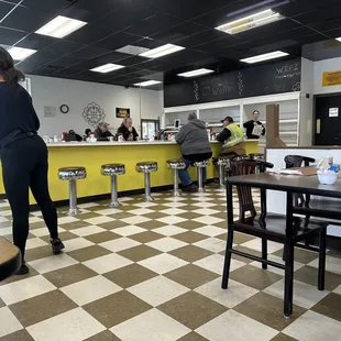 a woman standing in a restaurant
