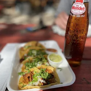 a bottle of beer and a plate of food