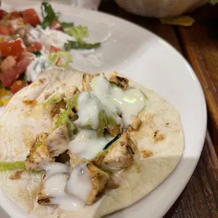 a taco and salad on a plate