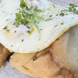 Pork tamales topped with over medium eggs