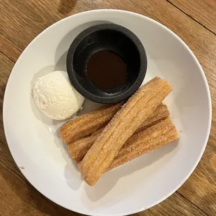 Churros, chocolate dipping sauce, and a sweet cream