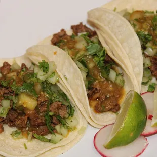 Regular Tacos Topped off with Onions, Cilantro and Salsa