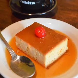 a piece of cake on a plate with a spoon