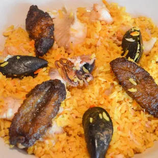 a plate of rice and seafood