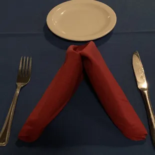 a place setting with napkins and silverware