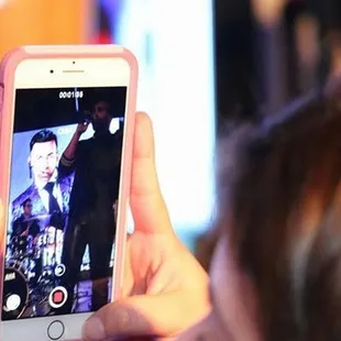 a woman taking a picture with her cell phone