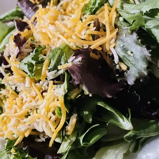 a salad with cheese and lettuce