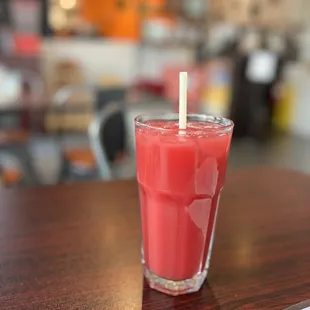 a glass of juice on a table