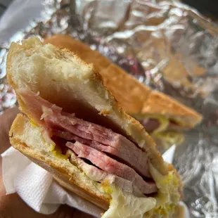 a hand holding a sandwich