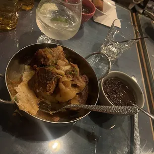 Fried pork belly with yuca and black beans. With a vodka soda. Absolutely delicious. Recommend!